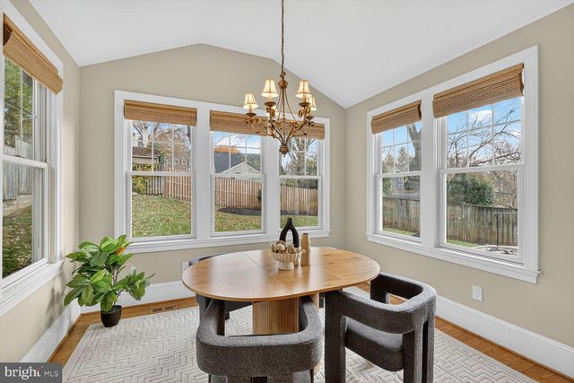 a dining room with furniture a window and a chandelier
