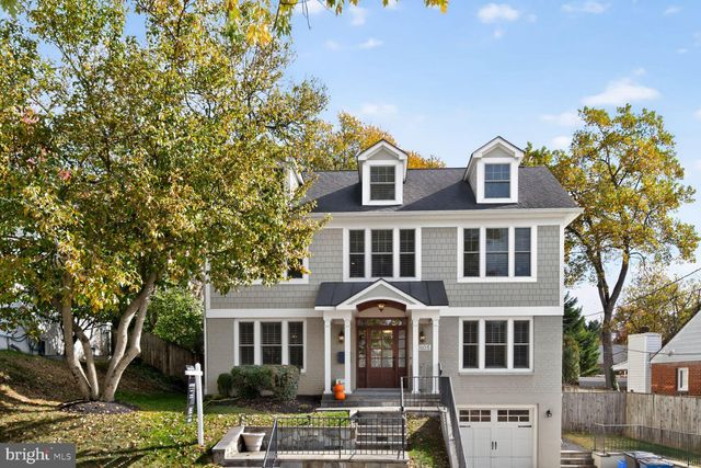 a front view of a residential houses with yard