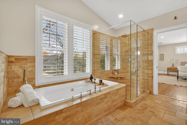 a spacious bathroom with a large tub and shower