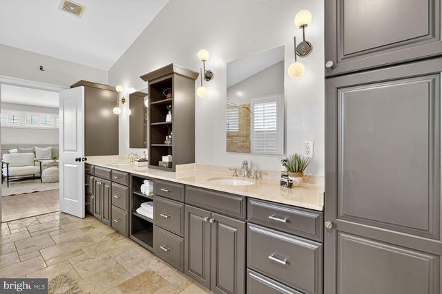 a bathroom with a double vanity sink and a mirror