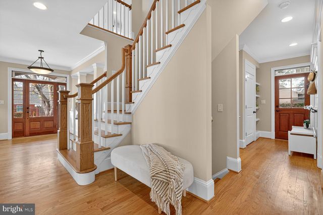 a view of entryway and hall with wooden floor