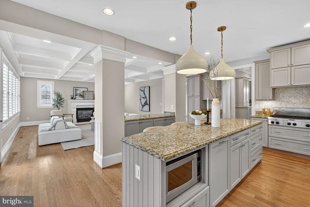 a kitchen with stainless steel appliances granite countertop a stove and cabinets