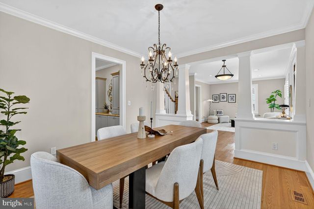 a dining room with a table and chairs