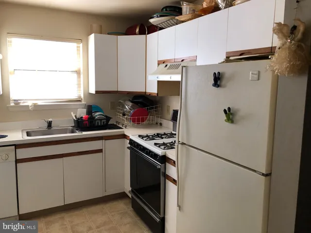 a kitchen with a refrigerator and window
