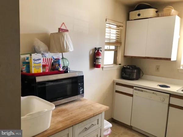 a kitchen with a sink a stove and cabinets