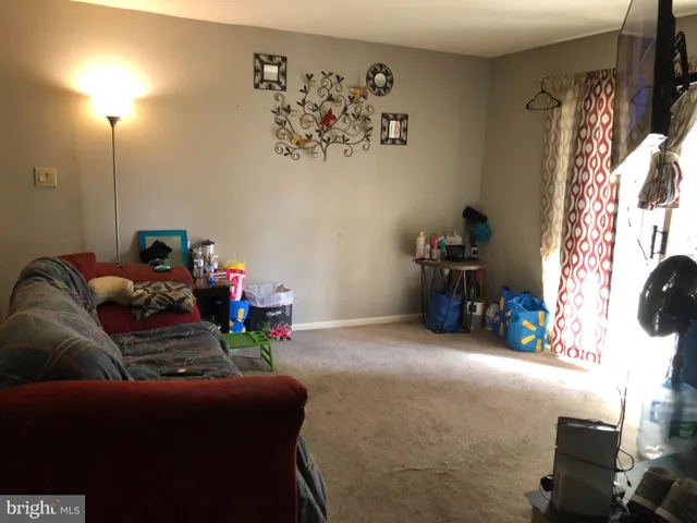 a view of a livingroom with furniture and a window