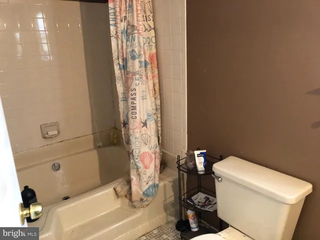 a bath room with a toilet and a bath tub