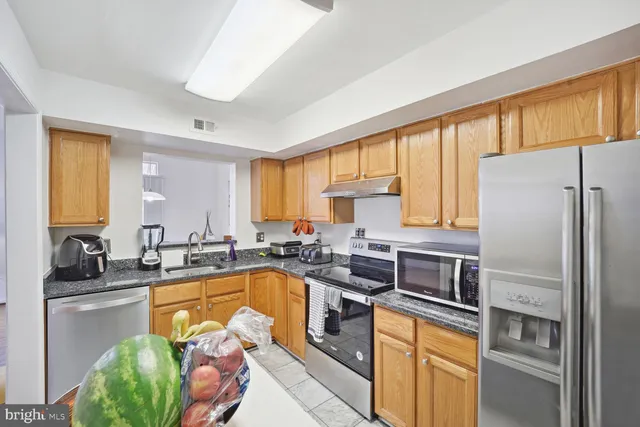 a kitchen with a sink stove and refrigerator