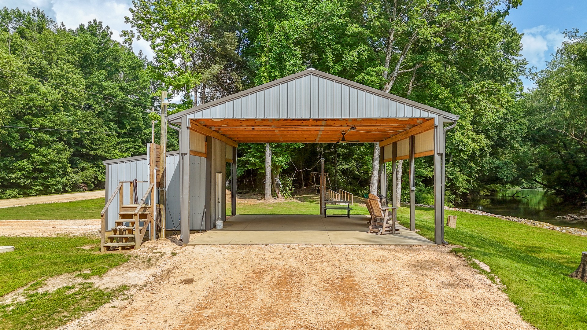 1820 Pinhook Road Savannah, TN 38372 - Photo 23 of 57 a view of backyard with table and chairs under an umbrella