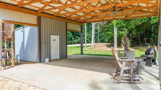 an aerial view of residential houses with outdoor space and trees