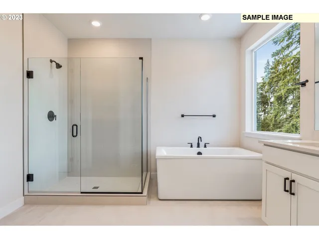 a bathroom with a double vanity sink mirror and bathtub