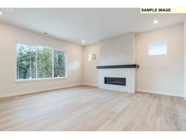 a living room with a fireplace and a wooden cabinets