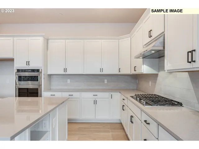 a kitchen with stainless steel appliances granite countertop a sink and cabinets