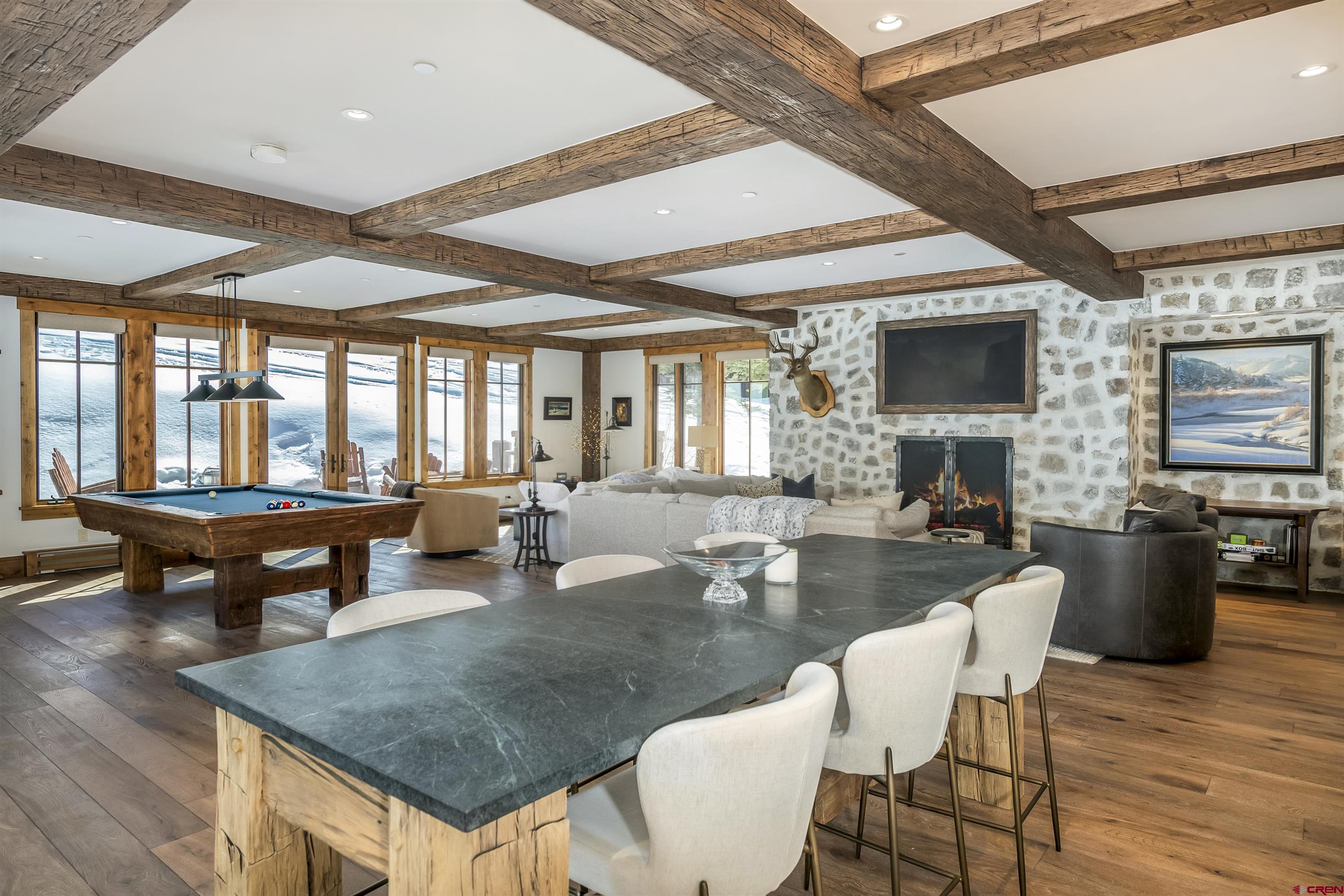 14 Hunter Hill Road, Unit C205 Crested Butte, CO 81225 - Photo 1 of 33 a dining table with chairs and couches with wooden floor