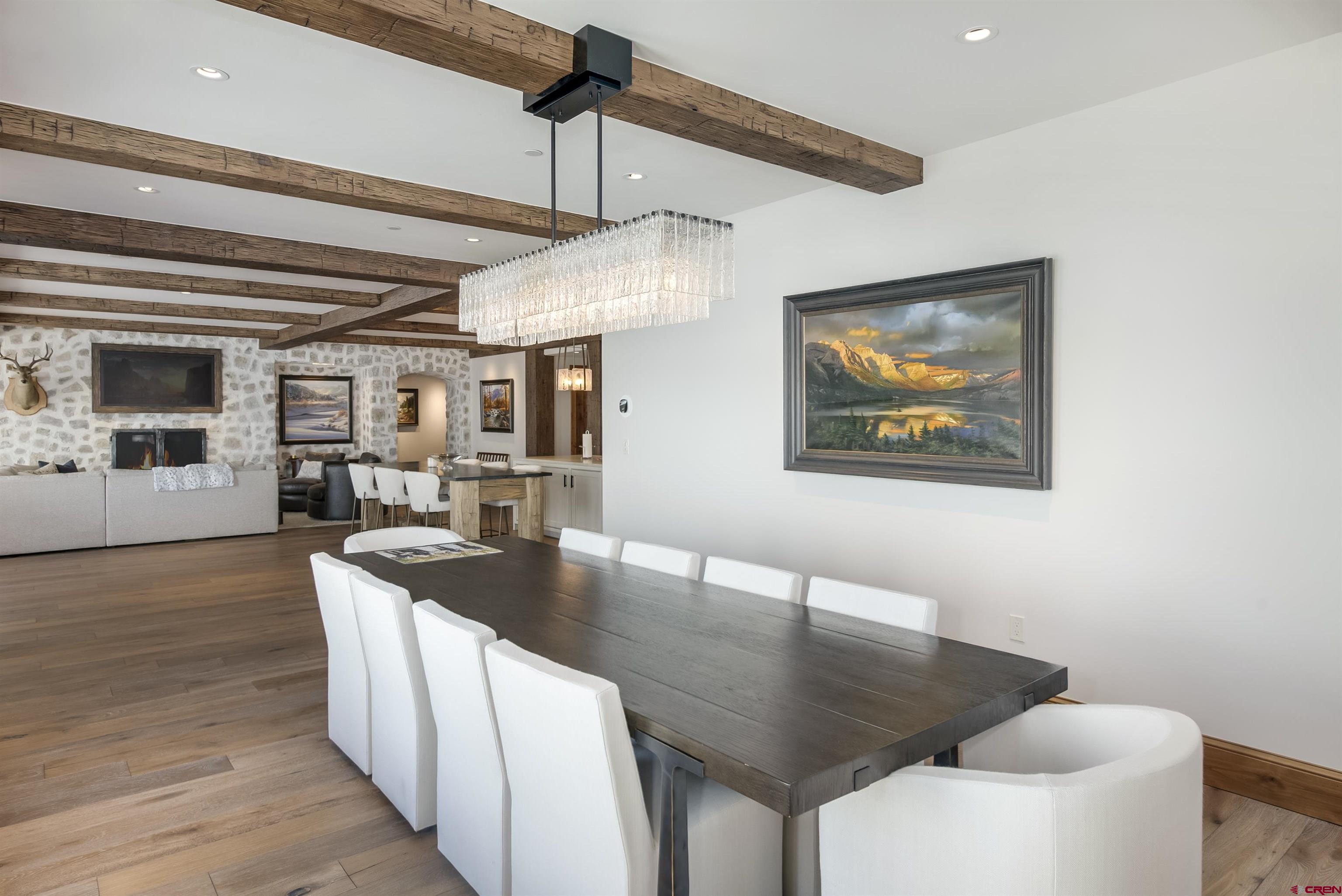 14 Hunter Hill Road, Unit C205 Crested Butte, CO 81225 - Photo 11 of 33 a dinning room with wooden floor and furniture