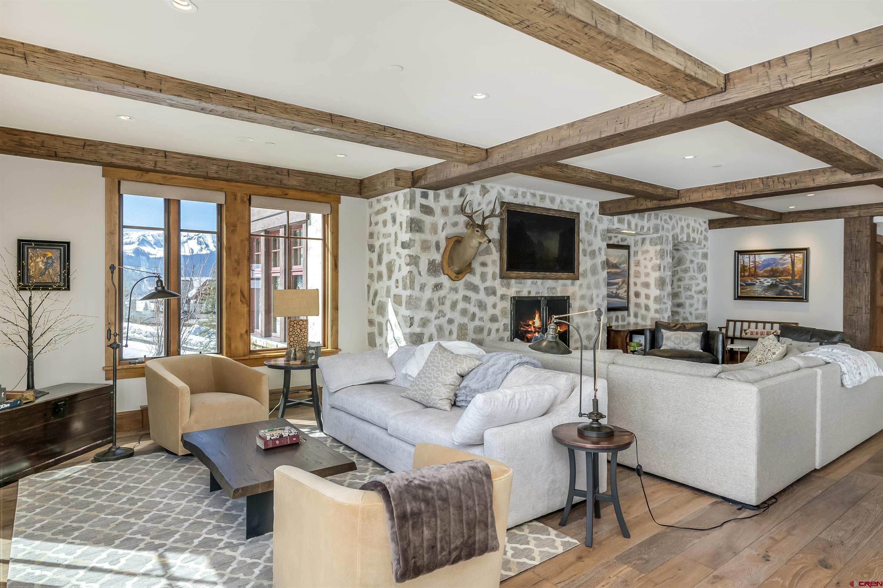 14 Hunter Hill Road, Unit C205 Crested Butte, CO 81225 - Photo 13 of 33 a living room with fireplace furniture and a flat screen tv