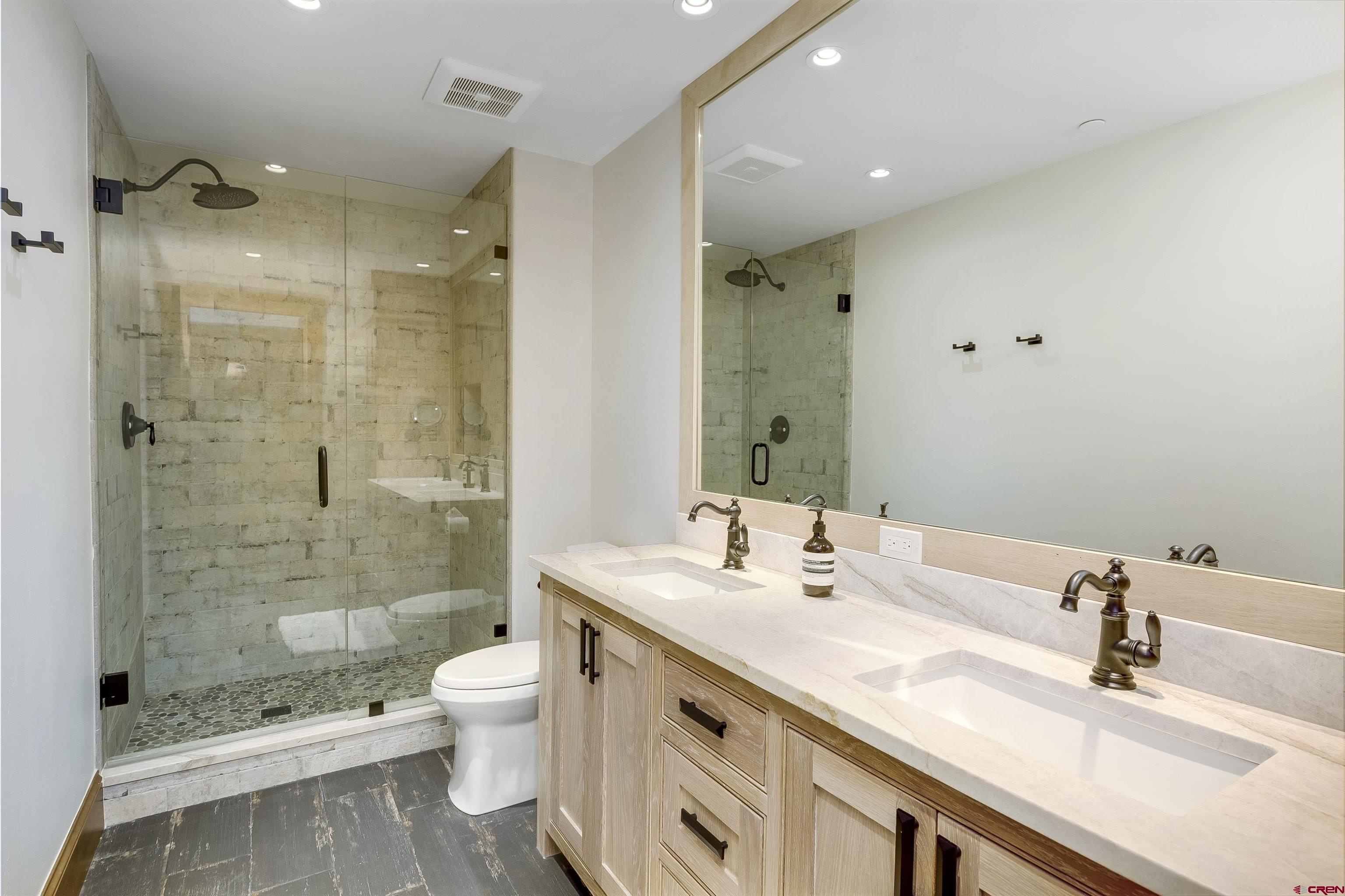 14 Hunter Hill Road, Unit C205 Crested Butte, CO 81225 - Photo 21 of 33 a bathroom with a granite countertop sink a toilet and shower