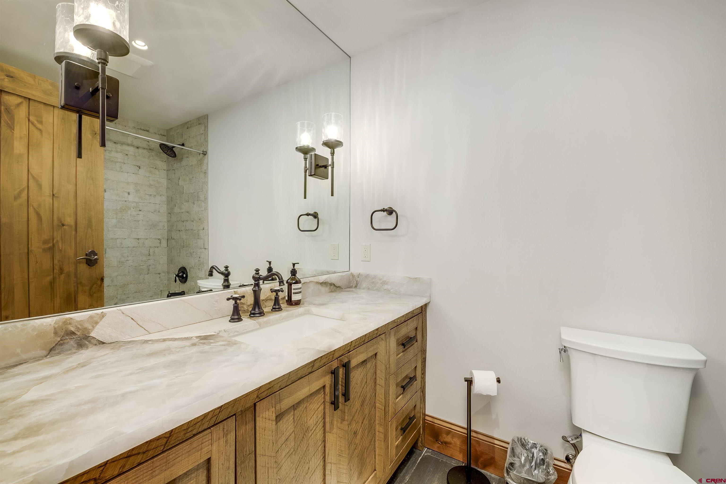 14 Hunter Hill Road, Unit C205 Crested Butte, CO 81225 - Photo 23 of 33 a bathroom with a sink a toilet and shower