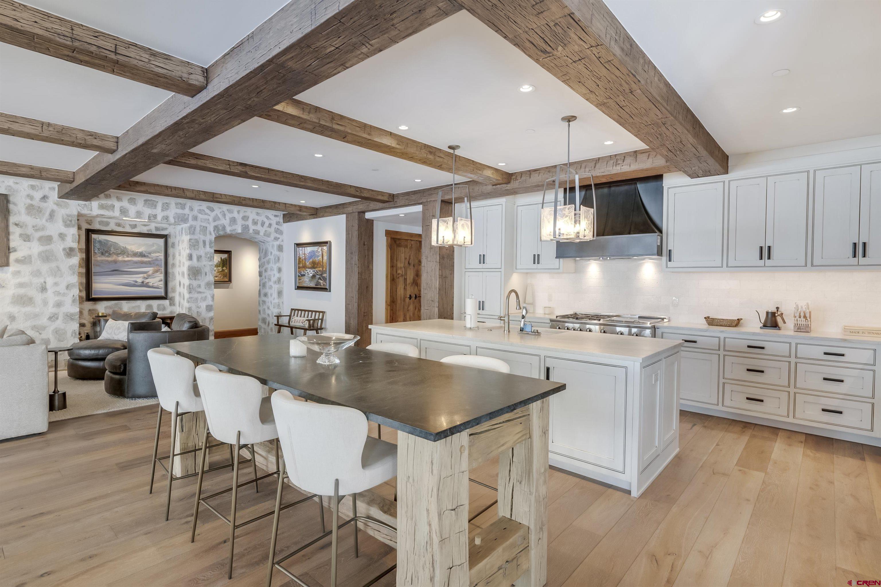 14 Hunter Hill Road, Unit C205 Crested Butte, CO 81225 - Photo 3 of 33 a kitchen with stainless steel appliances granite countertop a stove top oven a sink dishwasher and white cabinets with wooden floor