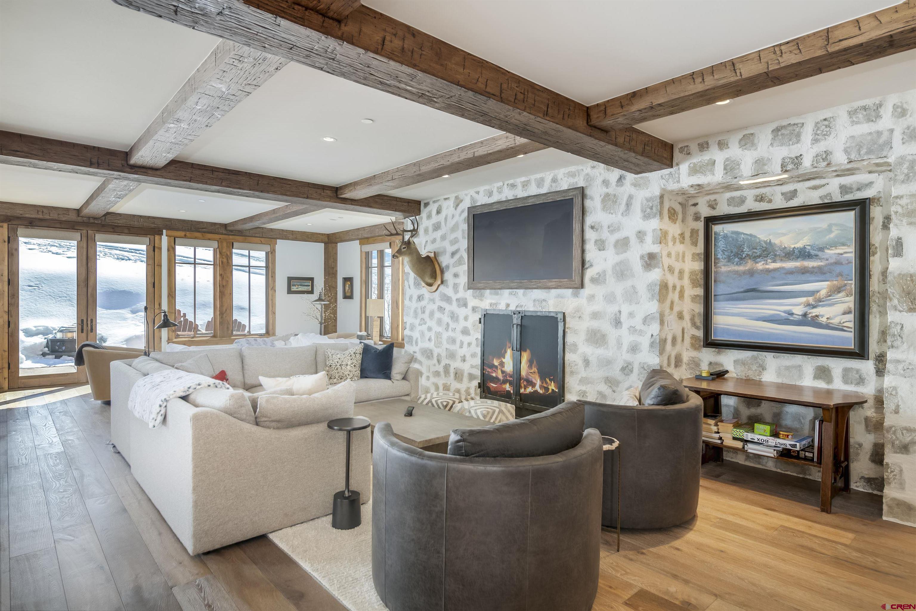 14 Hunter Hill Road, Unit C205 Crested Butte, CO 81225 - Photo 9 of 33 a living room with fireplace furniture and a flat screen tv