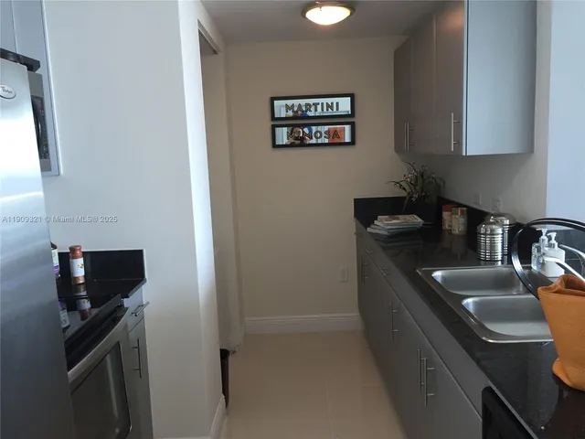 a kitchen with a sink and a stove top oven