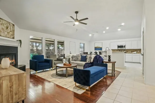 a living room with furniture and kitchen view