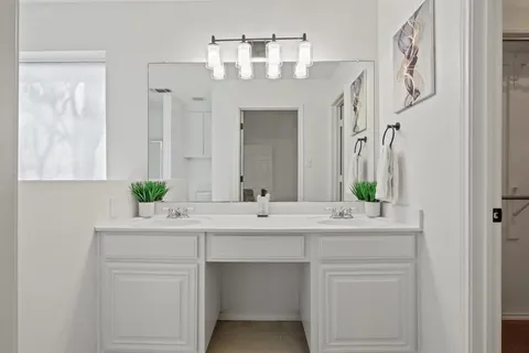 a bathroom with a double vanity sink and a mirror