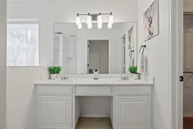 a bathroom with a double vanity sink and a mirror