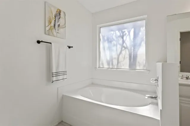 a white bath tub sitting next to a window