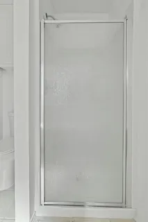a bathroom with a glass shower door