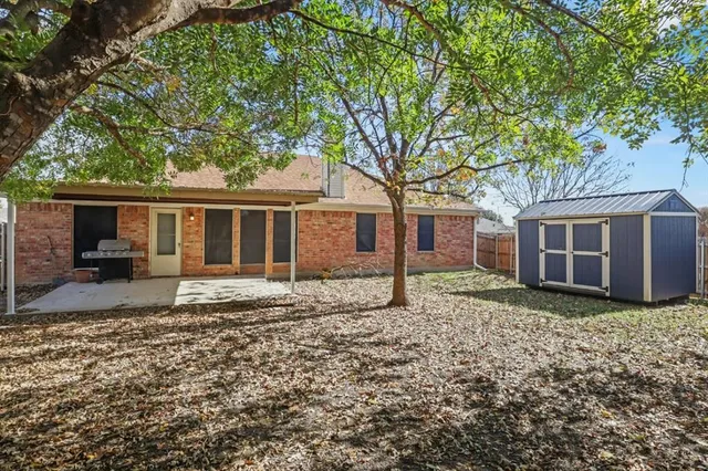 a house that has a tree in front of the house