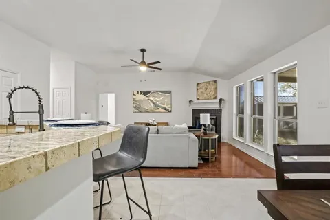a living room with furniture a fireplace and wooden floor