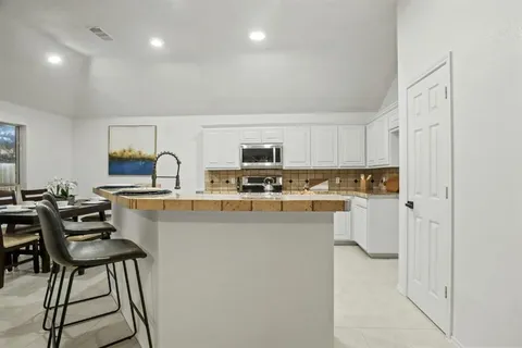 a kitchen with stainless steel appliances a refrigerator and a stove top oven