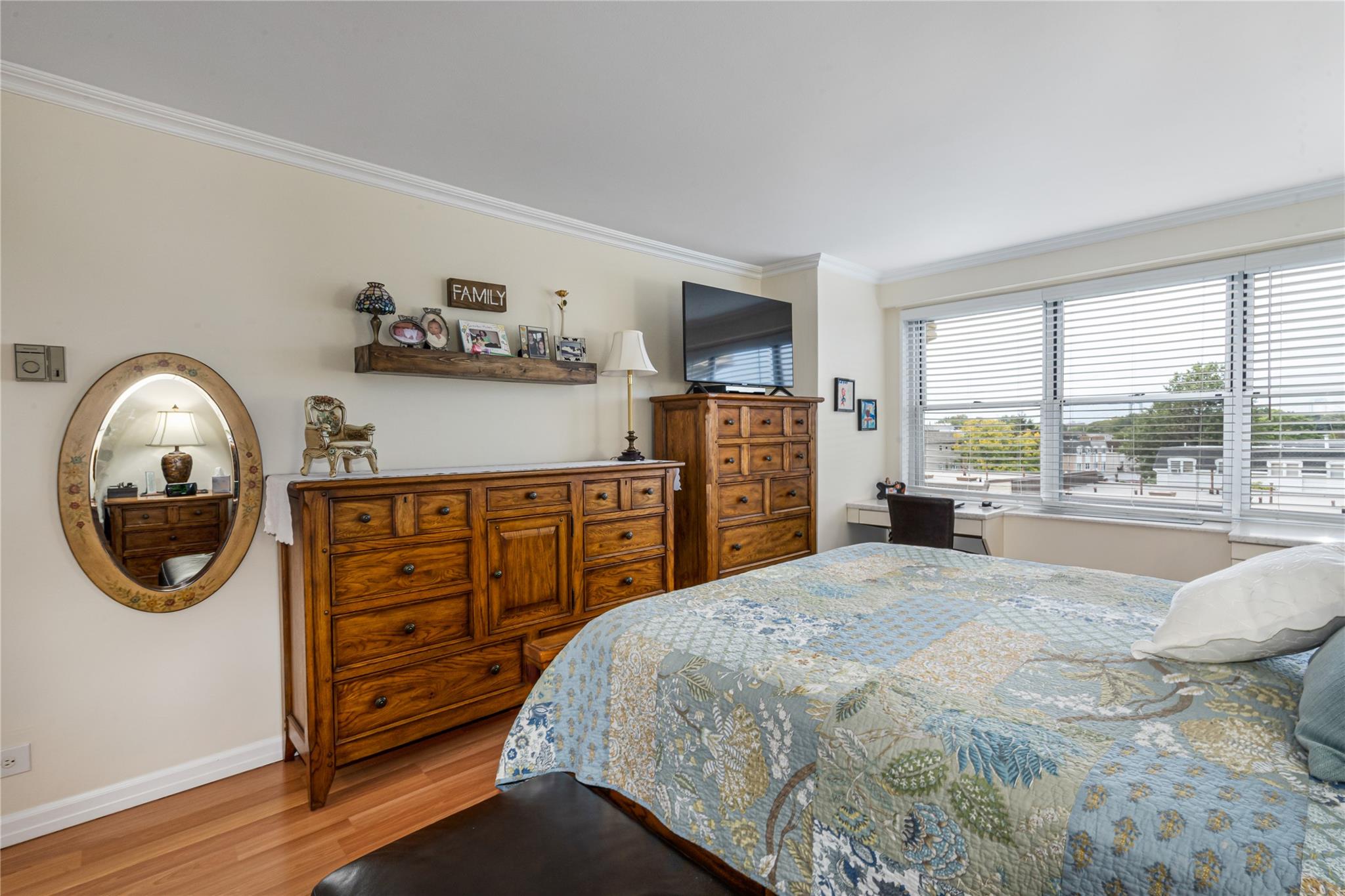 17-85 215th Street, Unit 4B Queens, NY 11360 - Photo 11 of 31 Bedroom with crown molding, light wood-style flooring, and baseboards