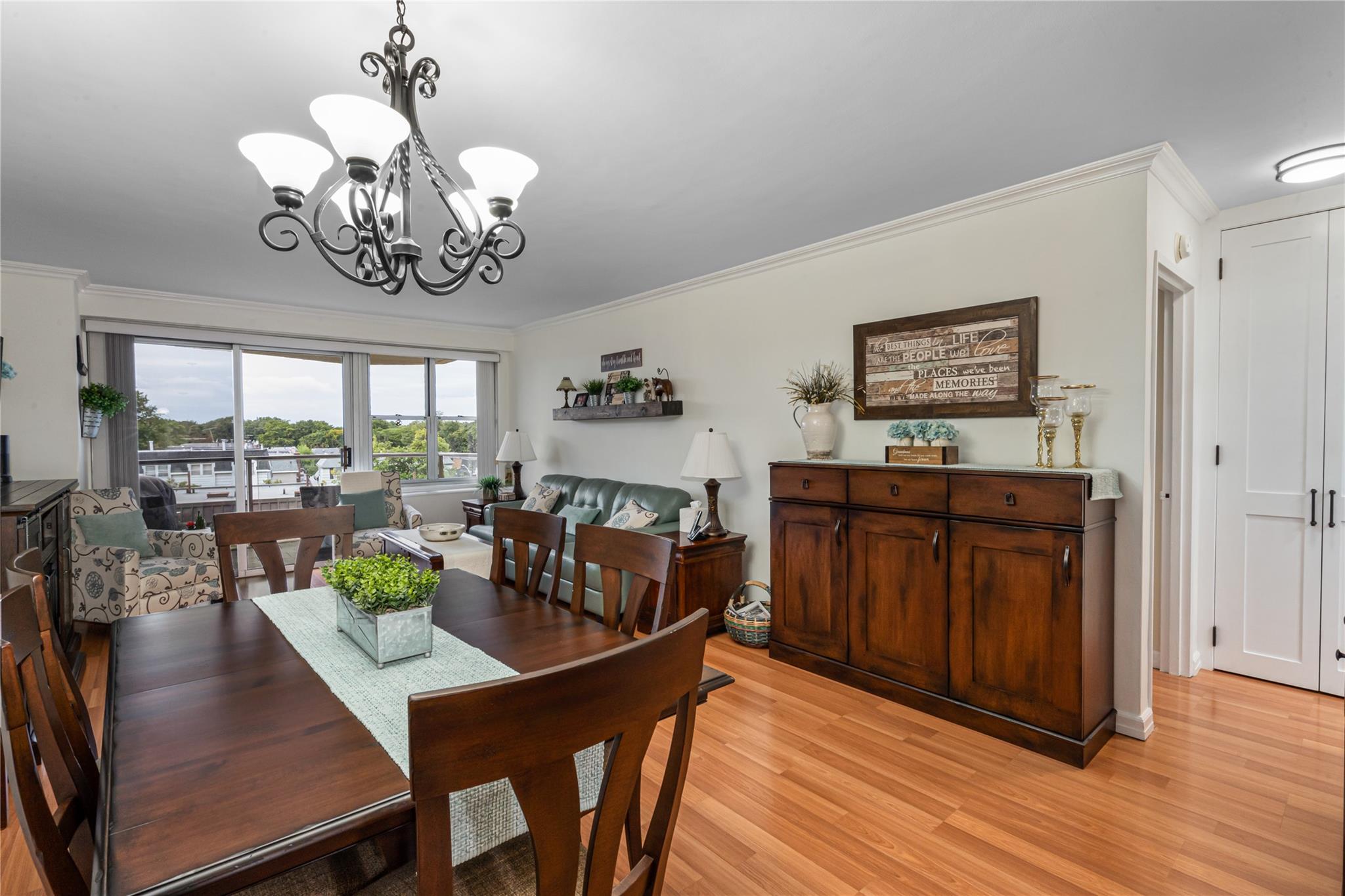 17-85 215th Street, Unit 4B Queens, NY 11360 - Photo 5 of 31 Dining space featuring a chandelier, crown molding, and light wood-style flooring
