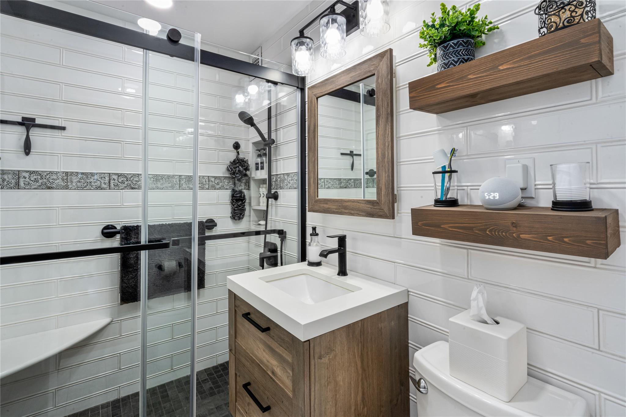 17-85 215th Street, Unit 4B Queens, NY 11360 - Photo 9 of 31 Bathroom with tile walls, a shower stall, vanity, and toilet