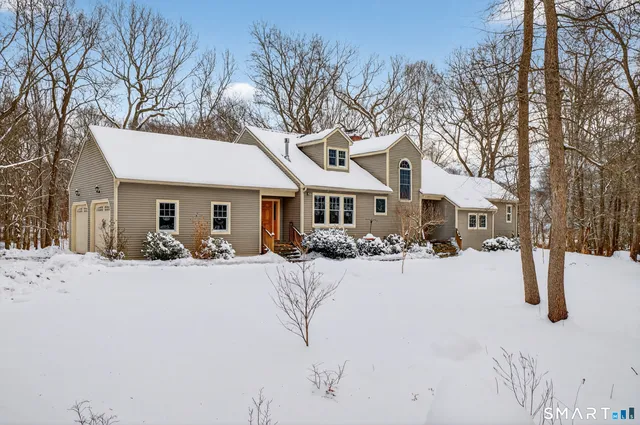 a front view of a house with a yard covered with snow in front of house