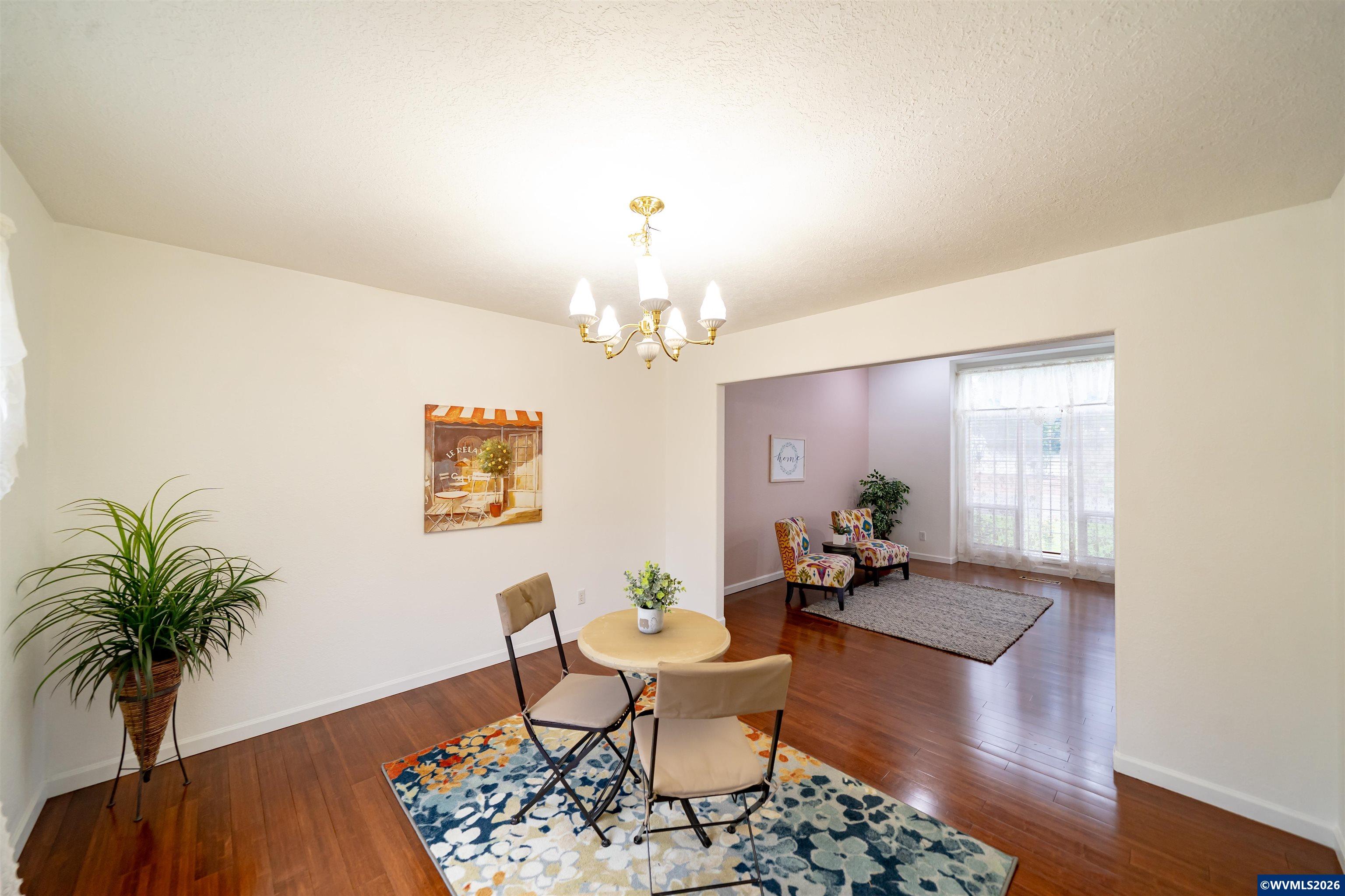 312 Southwest Cascade Meadow Drive Sublimity, OR 97385 - Photo 6 of 42 a living room with furniture and a chandelier