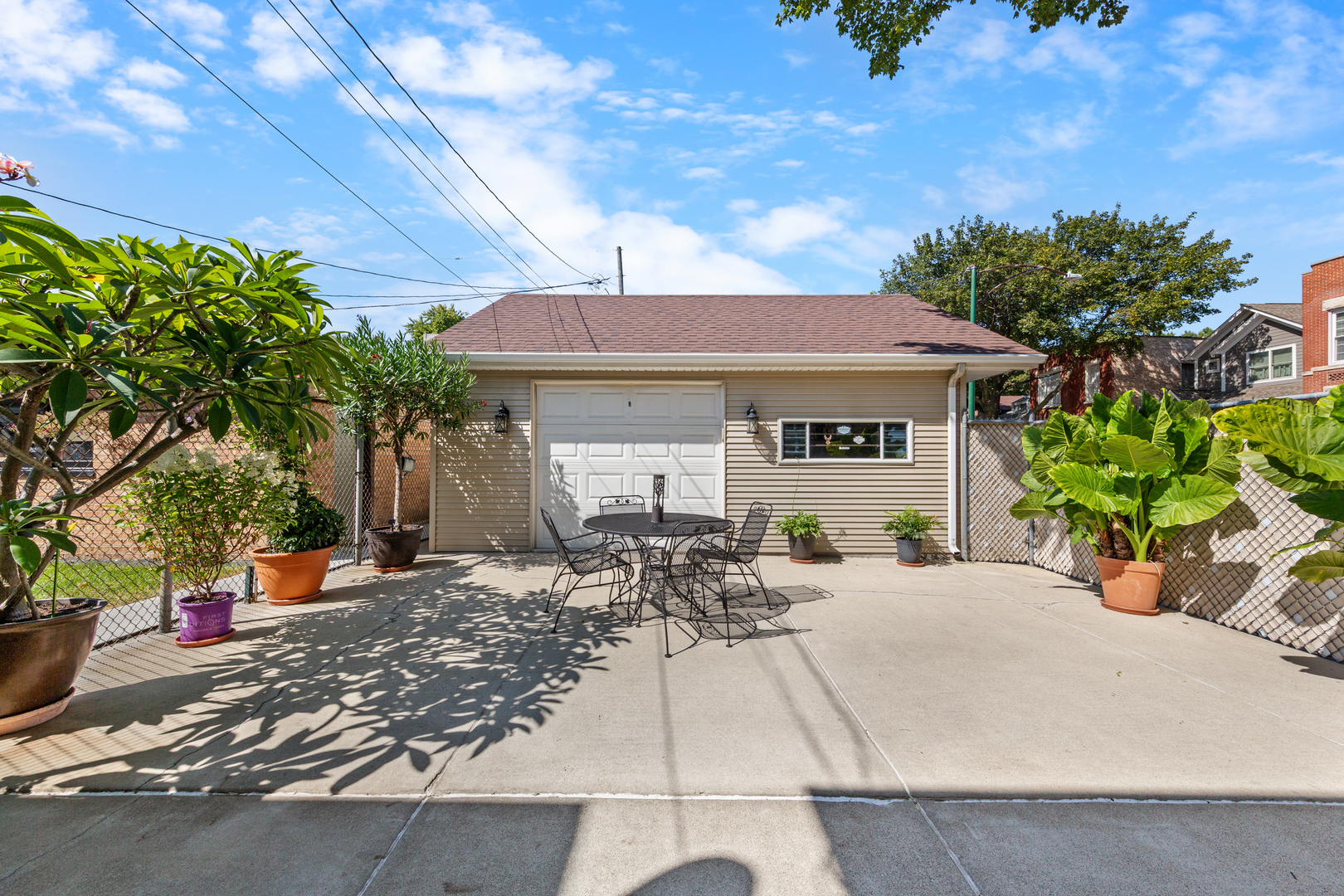 3700 South Normal Avenue Chicago, IL 60609 - Photo 30 of 36 a patio with table and chairs and potted plants