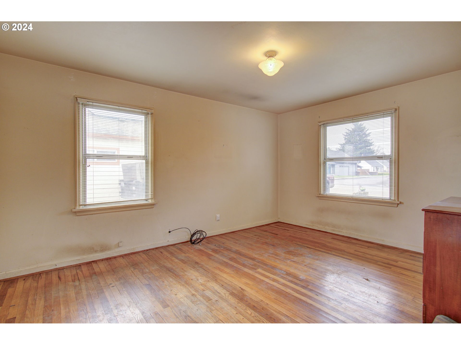 168 Southeast Whitney Street Camas, WA 98607 - Photo 16 of 32 a view of an empty room with a window and wooden floor