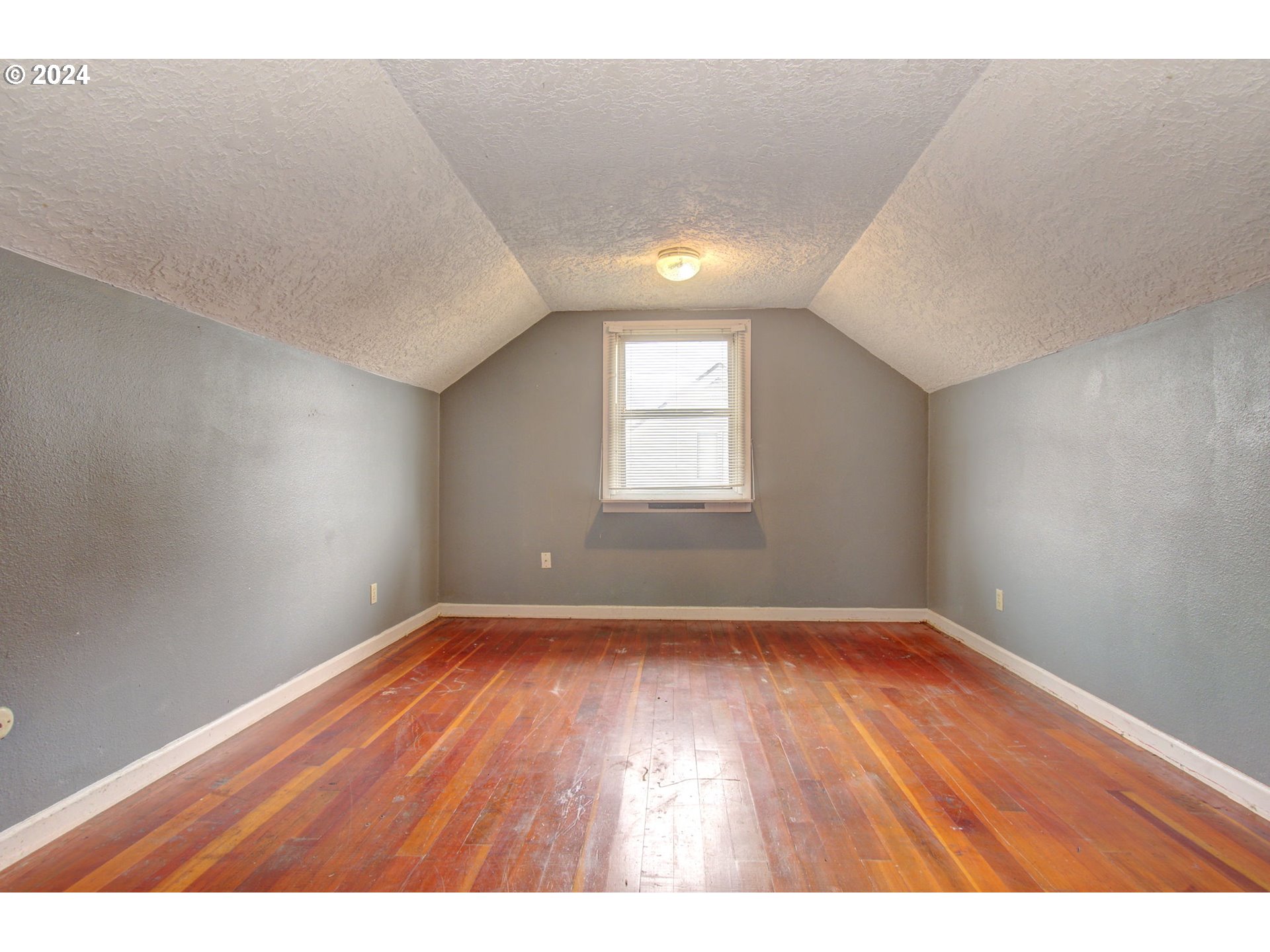 168 Southeast Whitney Street Camas, WA 98607 - Photo 24 of 32 a view of an empty room with wooden floor and a window