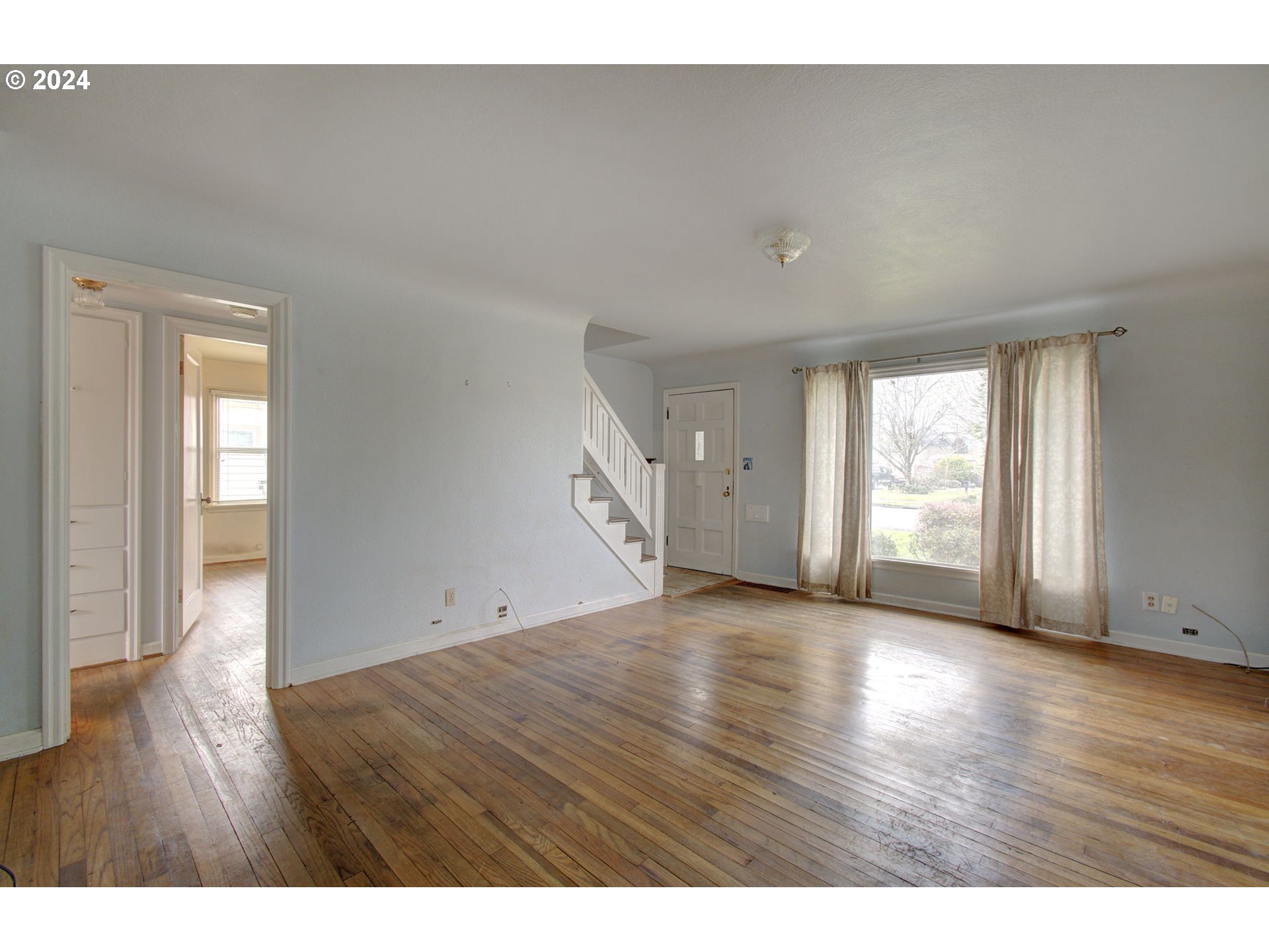 168 Southeast Whitney Street Camas, WA 98607 - Photo 5 of 32 a view of an empty room with wooden floor and windows