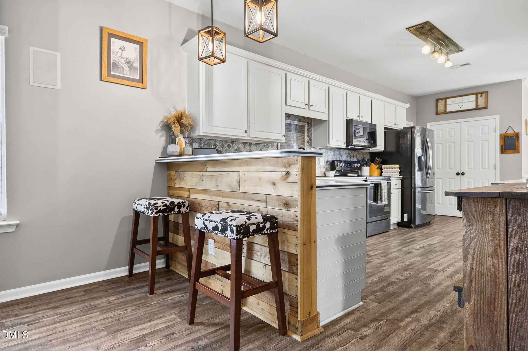 25 Hillside Village Drive Louisburg, NC 27549 - Photo 12 of 35 a view of kitchen with stainless steel appliances cabinets and wooden floor