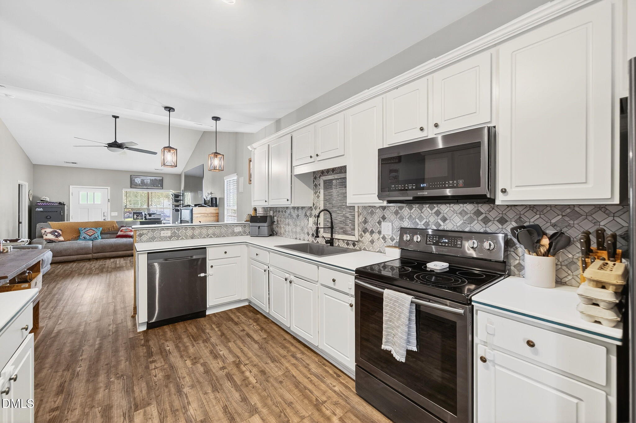 25 Hillside Village Drive Louisburg, NC 27549 - Photo 16 of 35 a kitchen with a sink stove and microwave