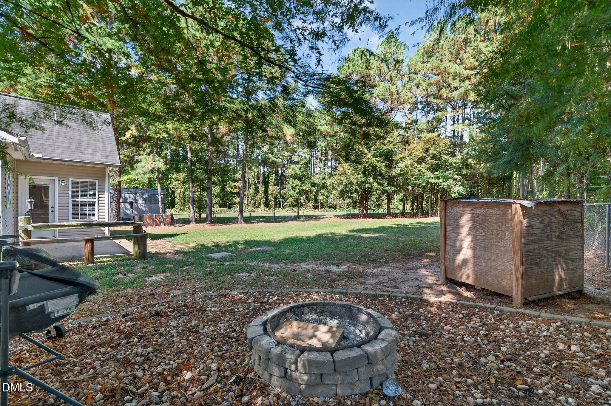 25 Hillside Village Drive Louisburg, NC 27549 - Photo 28 of 35 a view of a backyard with table and chairs