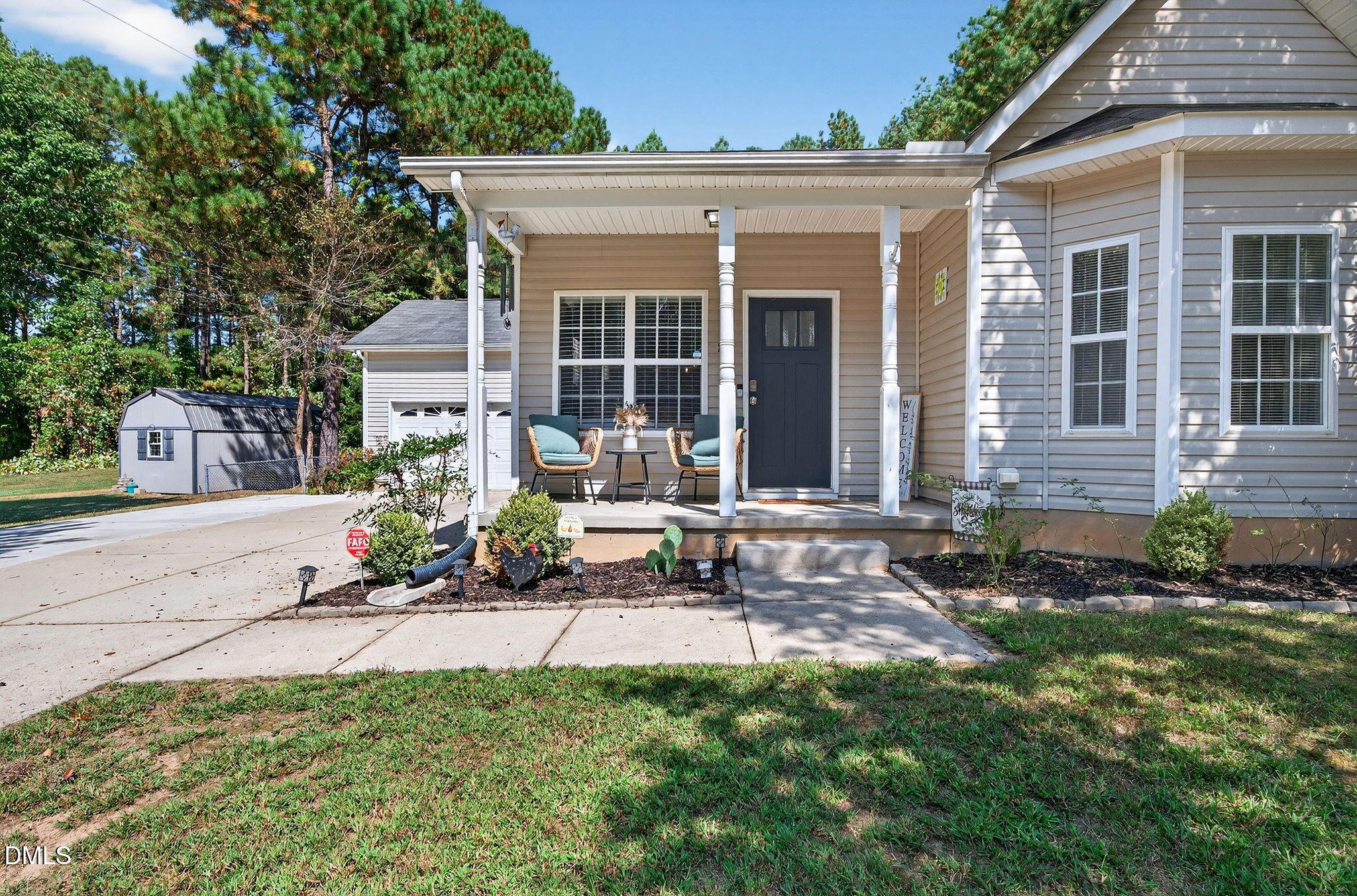 25 Hillside Village Drive Louisburg, NC 27549 - Photo 4 of 35 a view of a house with backyard sitting area and garden