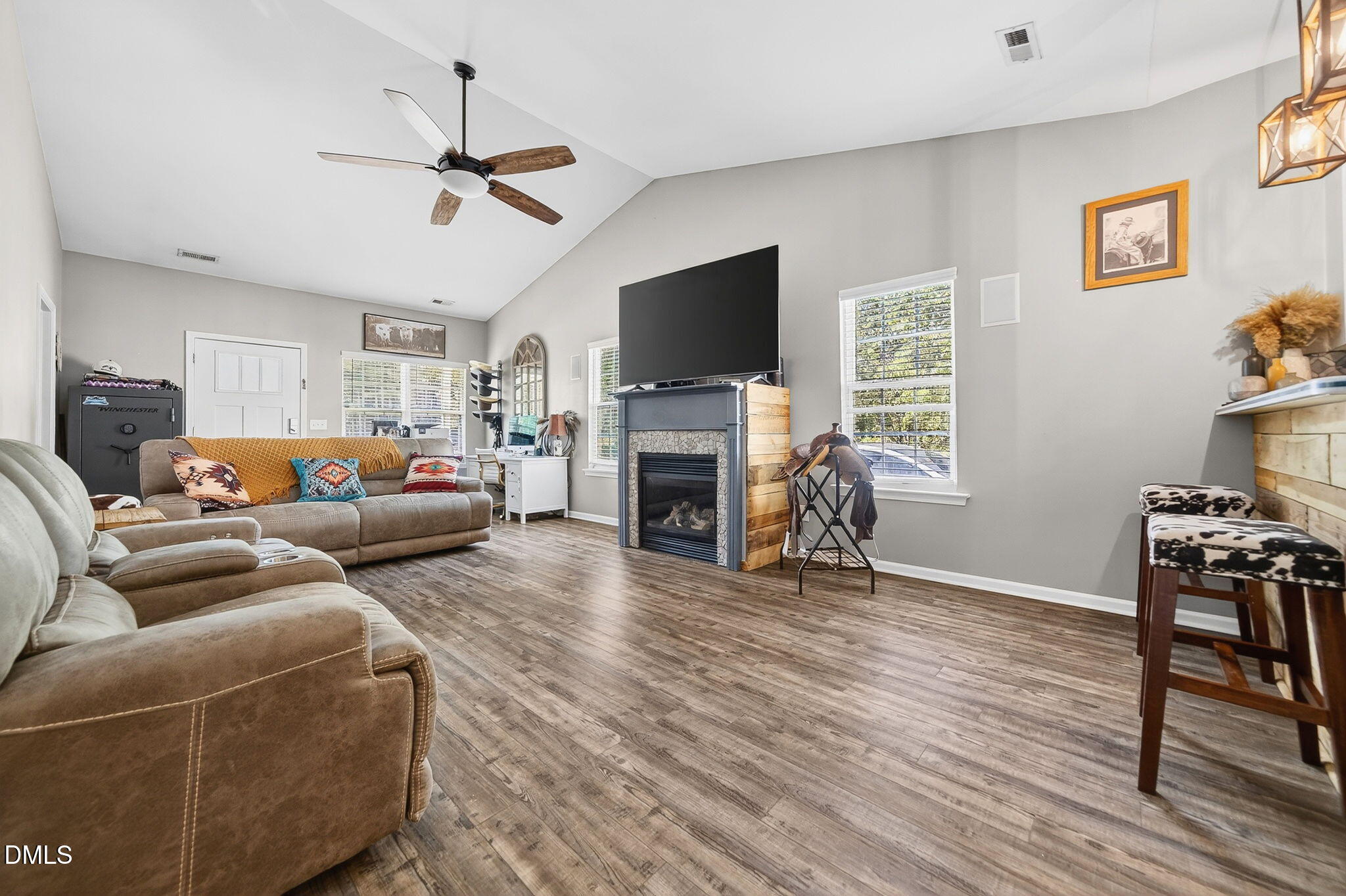 25 Hillside Village Drive Louisburg, NC 27549 - Photo 8 of 35 a living room with furniture a flat screen tv and a fireplace