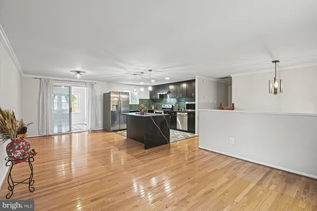 a view of kitchen with furniture and wooden floor