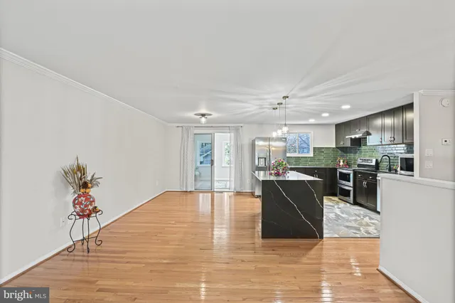 a living room with furniture and kitchen view