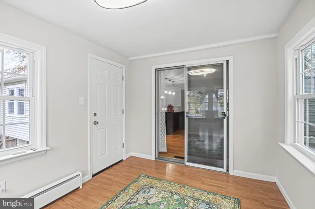 a view of a room with wooden floor and windows